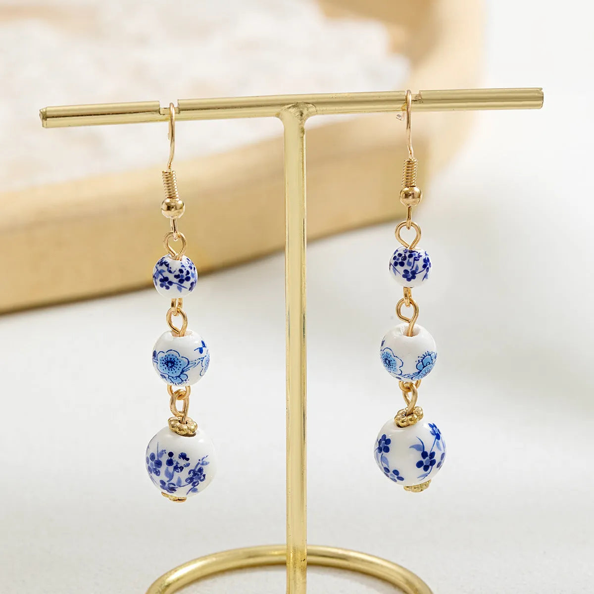Blue and white porcelain ceramic bead long drop earrings with geometric alloy design