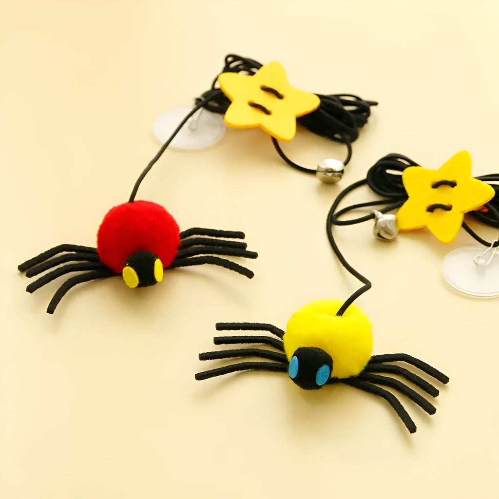Cat hanging door toy with elastic rope, feather stick, bell, and spider decoration in red or yellow colours