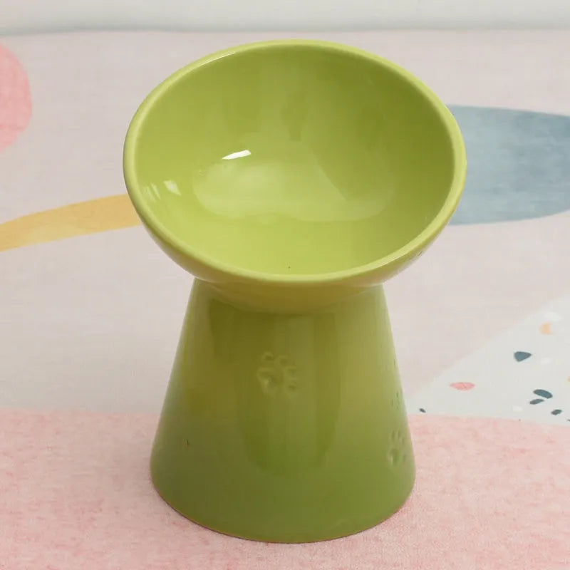 Black chin-high foot ceramic pet bowl for dogs and cats on a flat surface.