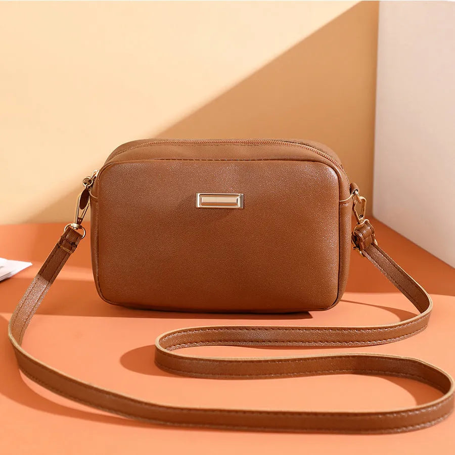 Women's solid colour PU shoulder bag with a three-dimensional pocket and horizontal square shape.